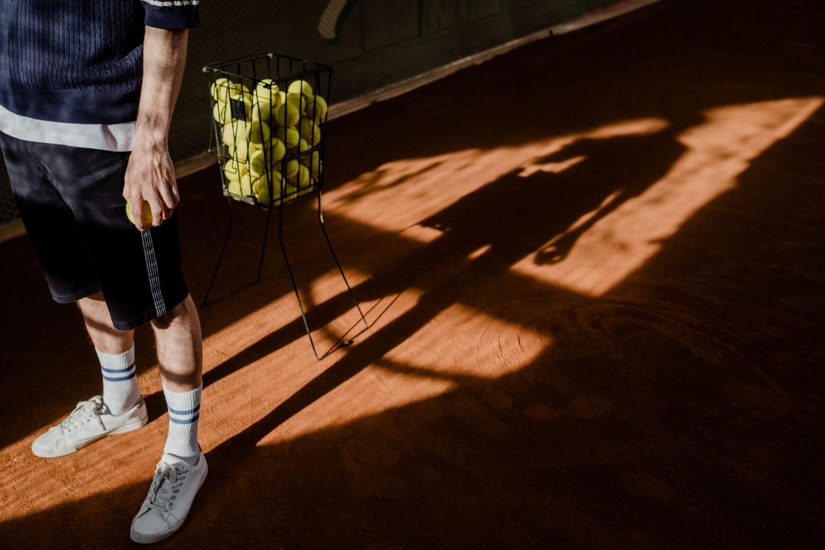 Juniors on clay with tennis ball hopper
