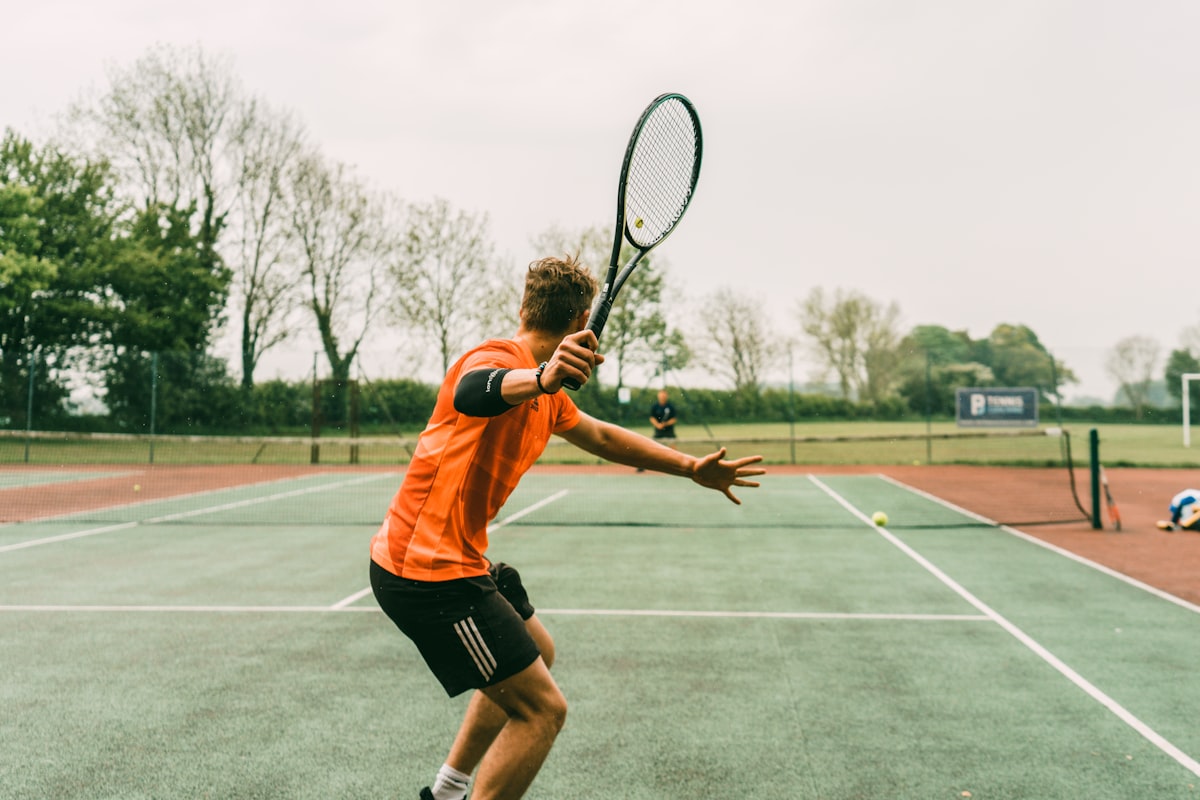 Player hitting tennis on blue court